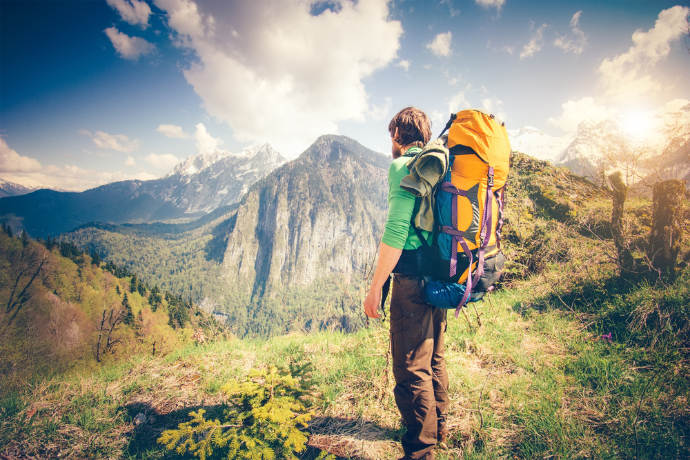 young man hiking with a backpack on