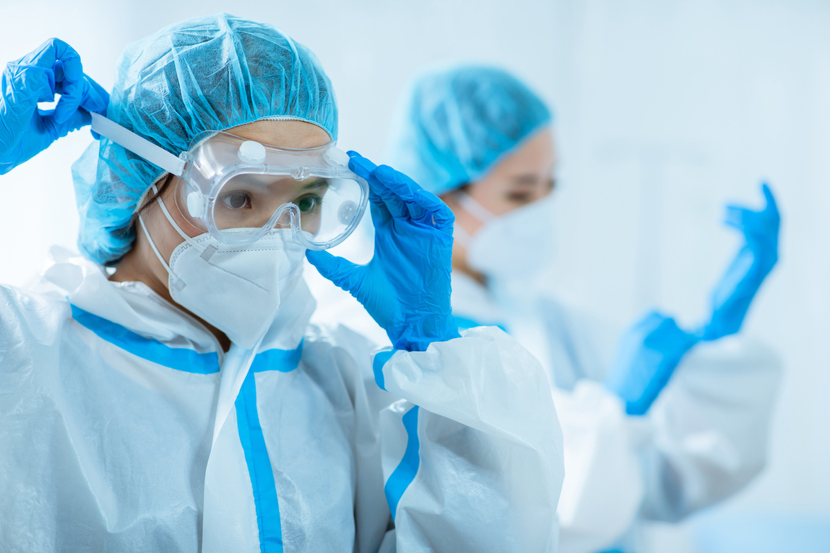 doctors wear protective suits at hospital