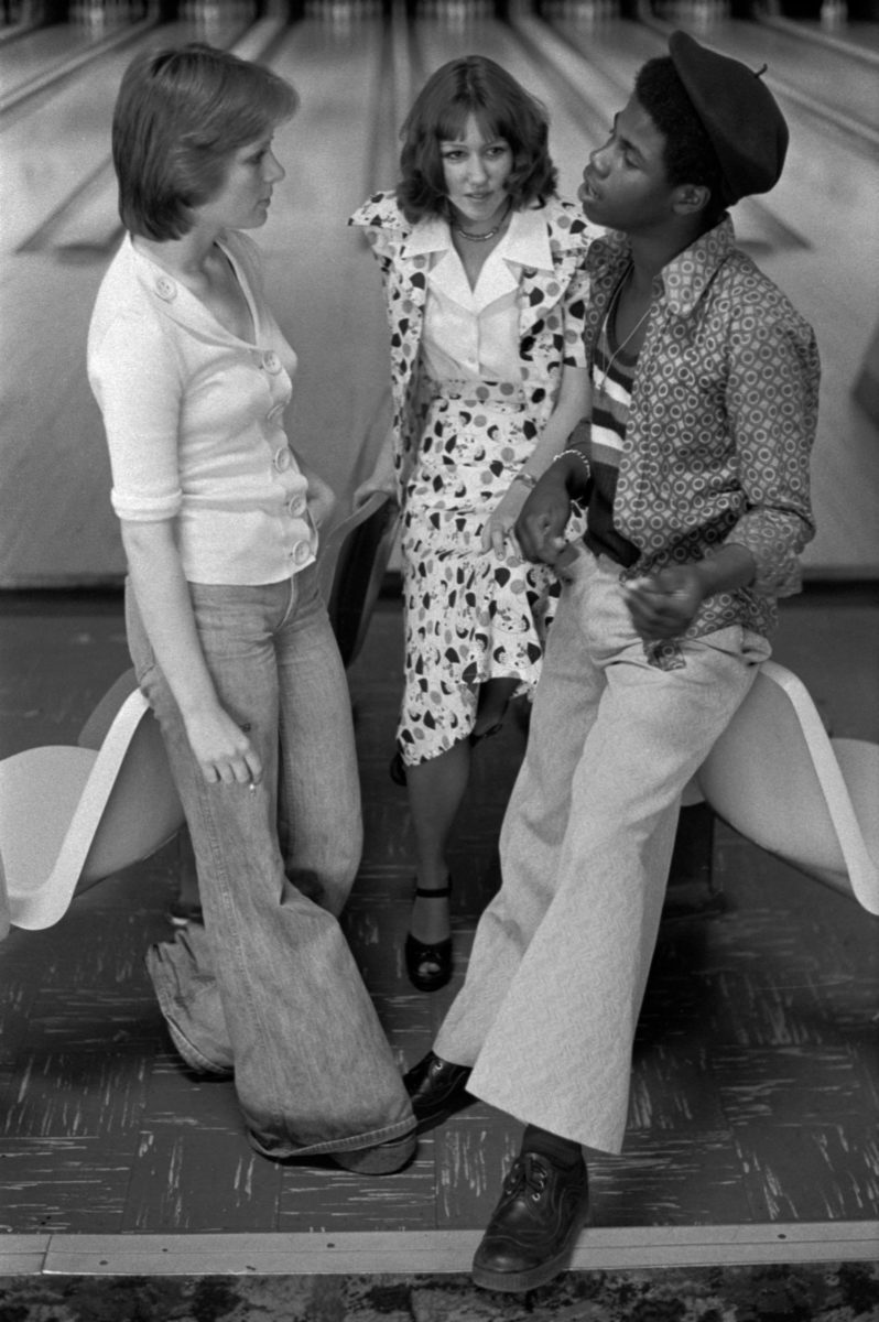 Teenagers hanging out at bowling alley in 1970s, wearing bellbottoms