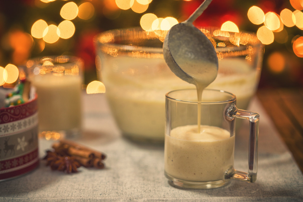 Holiday eggnog being poured into glasses. 