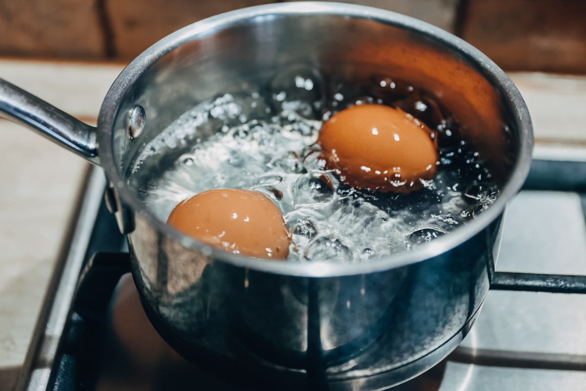 Saucepan with boiling eggs on the stove