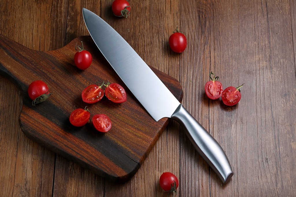 Sharp knife chopping tomatoes