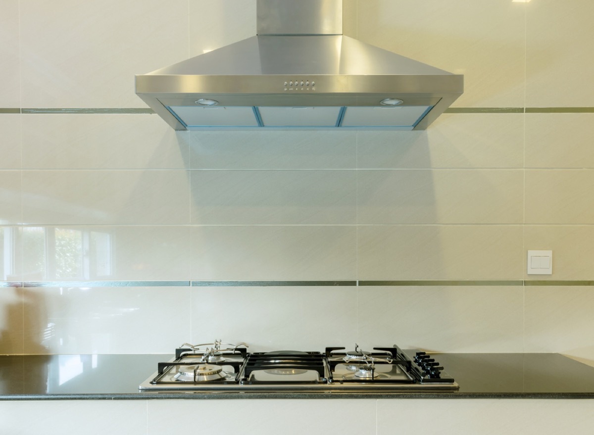 silver range hood over gas stove