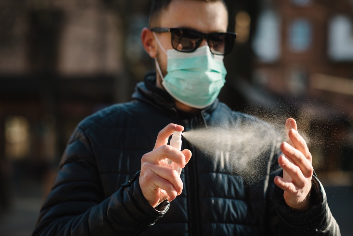 Man using sanitizing spray