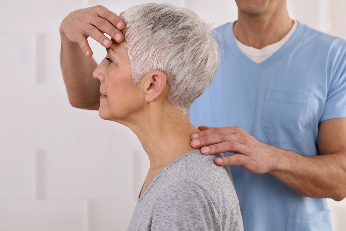 Mature woman having neck adjusted