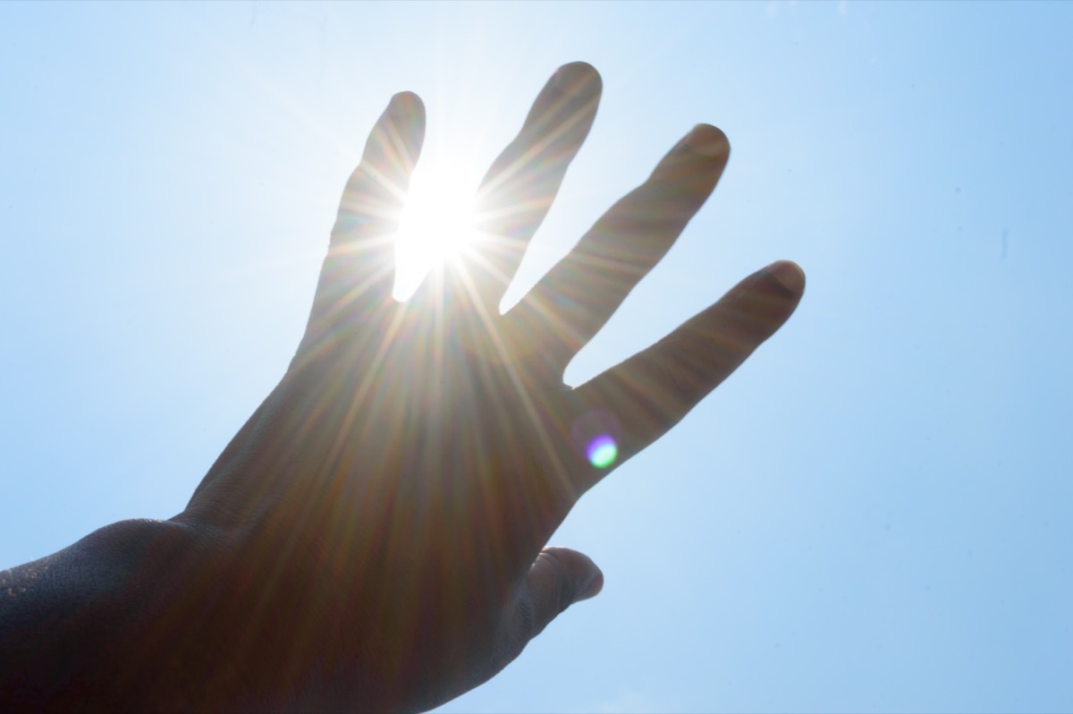 person trying to block the sun with their hand