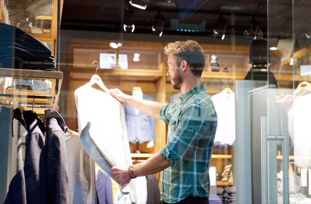 man shopping for shirts and suits in a clothing store Retail Store Layouts