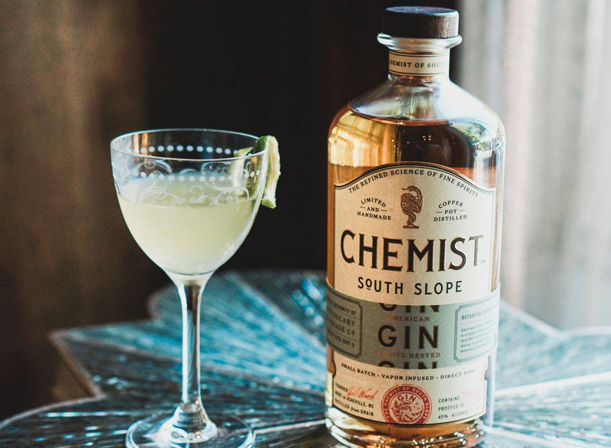 the chemist gin cocktail glass with bottle of housemade gin