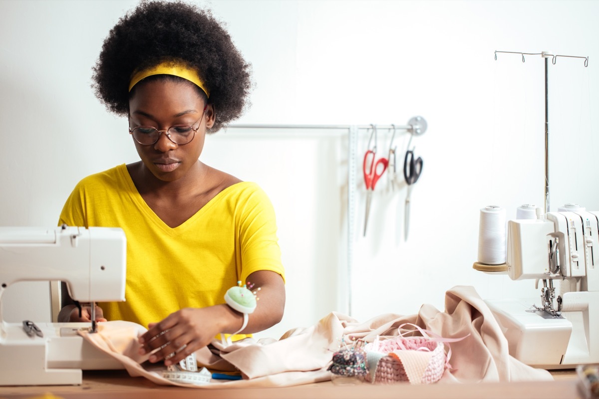 Woman seamstress with sewing machine