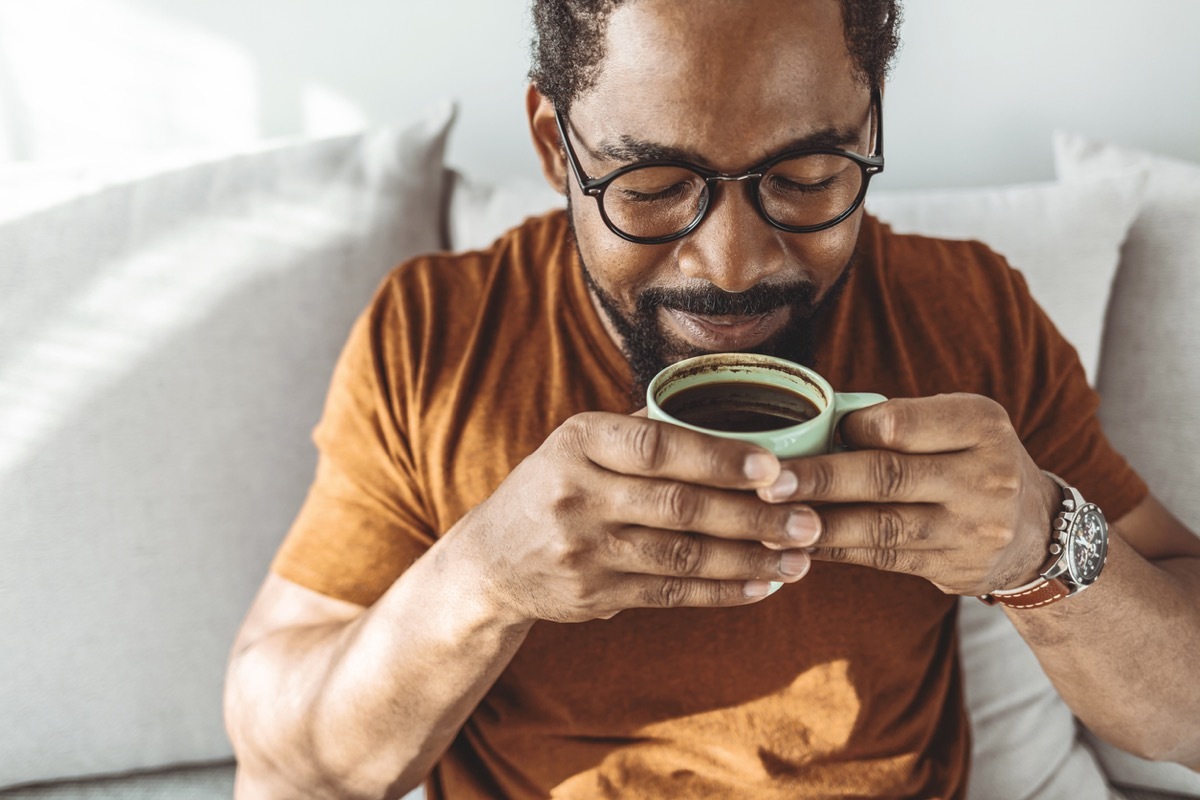 Cropped shot of a handsome young man relaxing with a cup of coffee