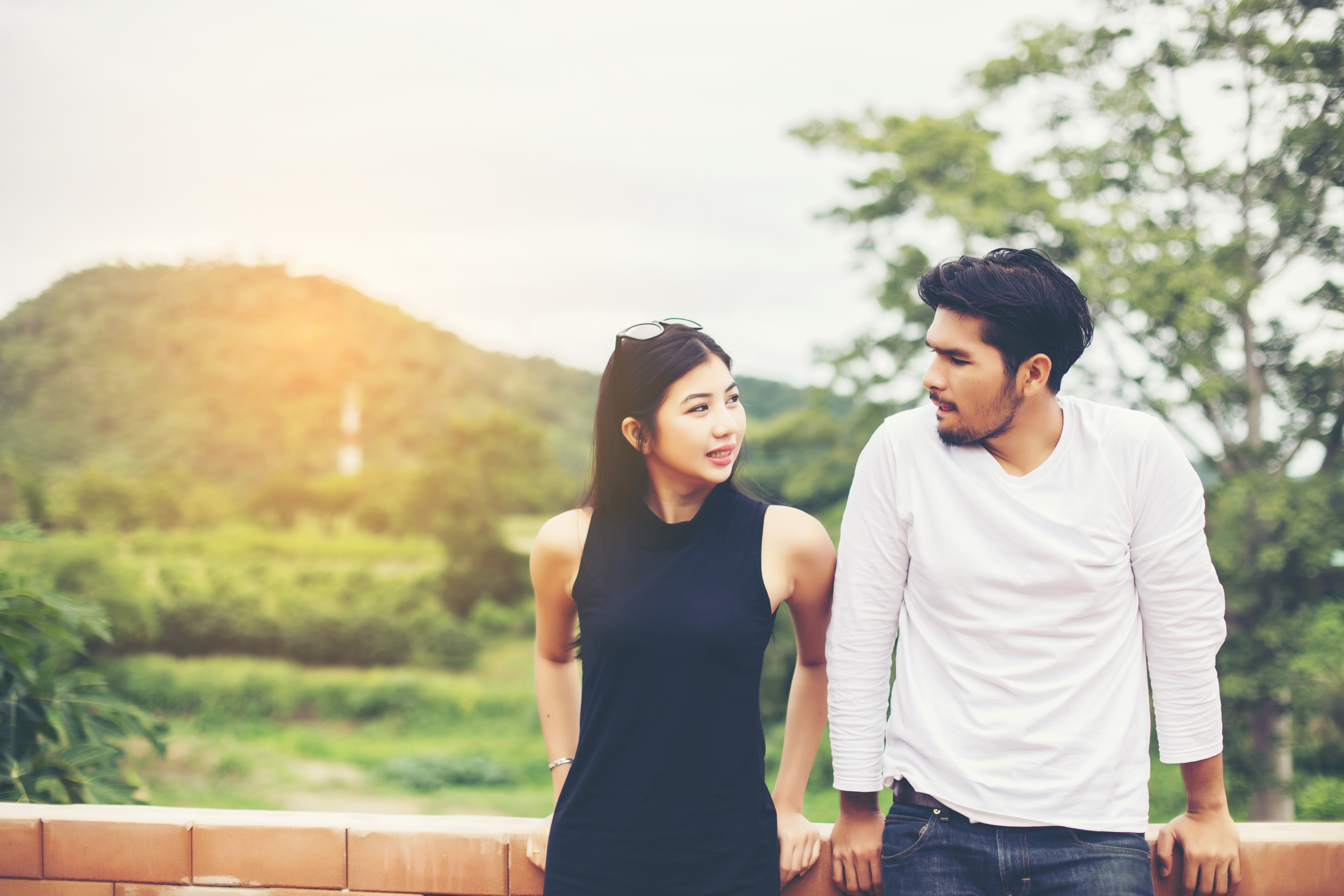 couple leaning on fence and asking intimate questions