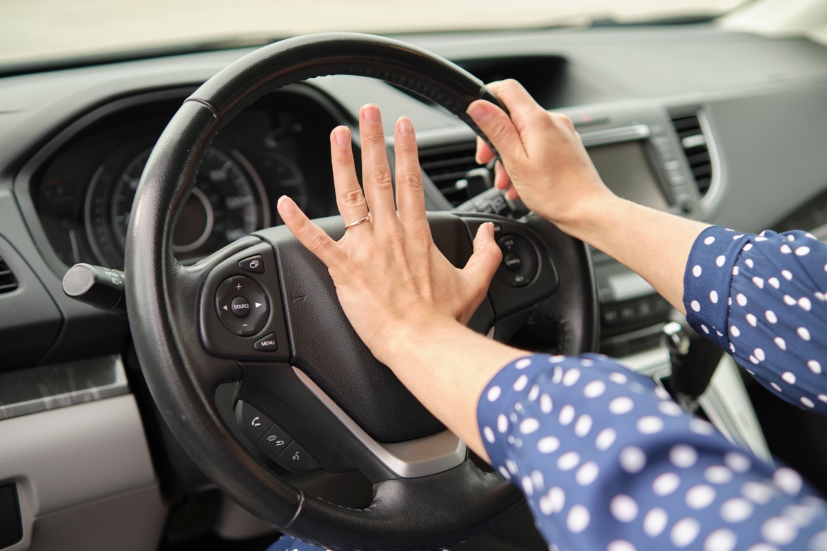 woman honking her car horn