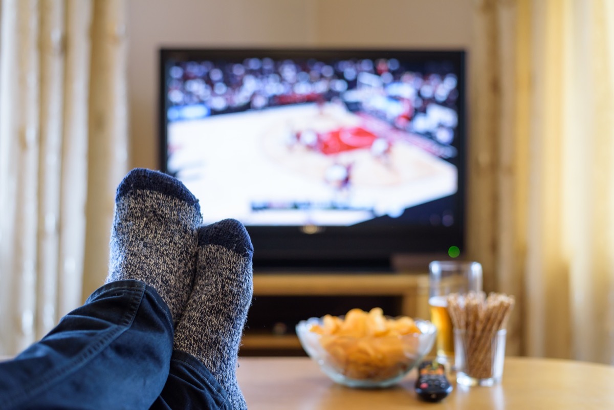 Man watching tv with snacks and beer