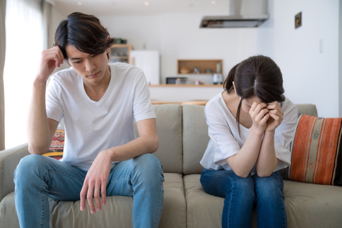 asian couple fighting on couch, things you should never say to your spouse