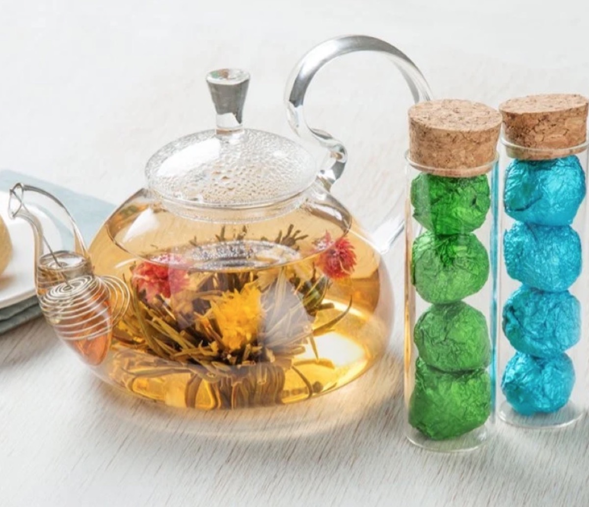 clear tea pot full of blooming tea