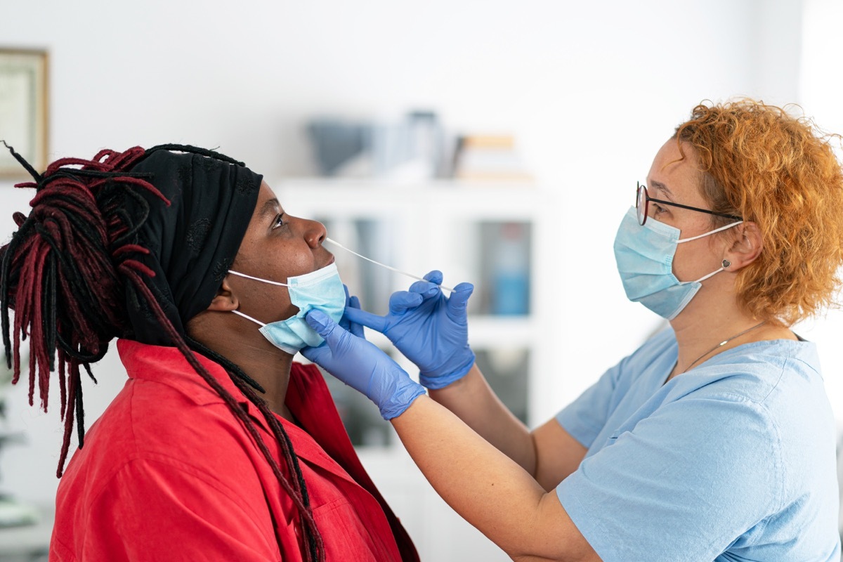 woman having a nasal swab test for Covid-19