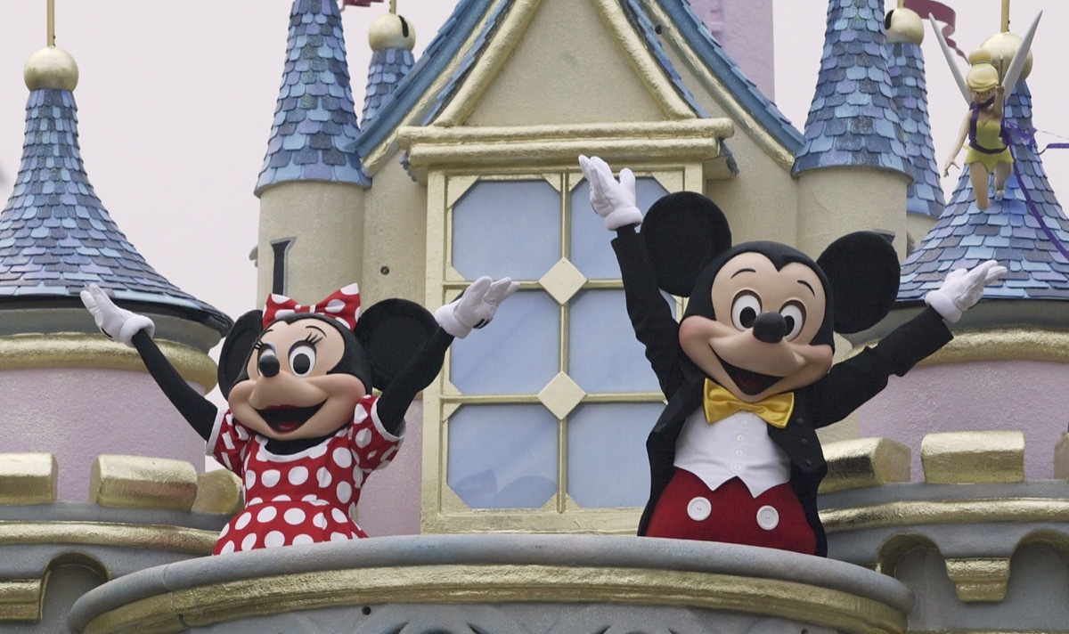 mickey and minnie mouse with hands up