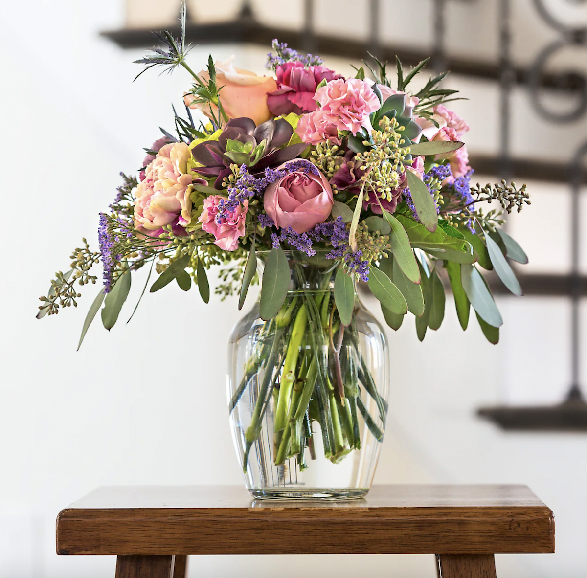 Glass vase from Dollar Tree shown with pink and purple flowers