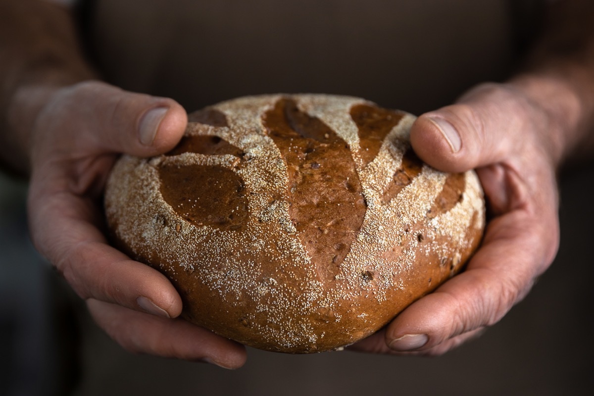 man holding a loaf of bread