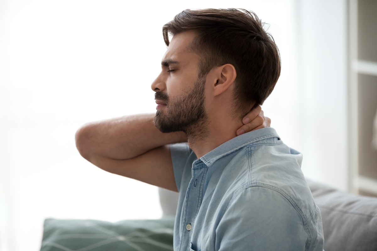 Man experiencing neck pain because of fibromyalgia