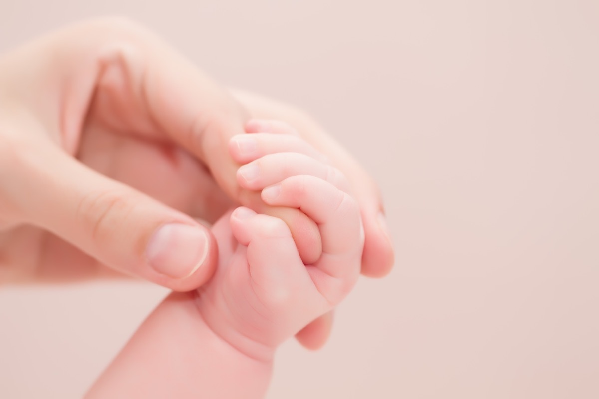 Baby's hand grasps mom's finger, husband left while pregnant