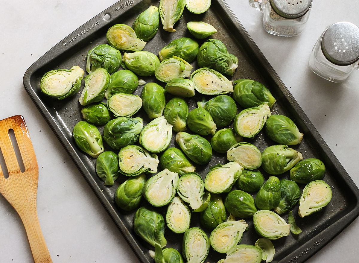 prepping brussels sprouts to be roasted in the oven