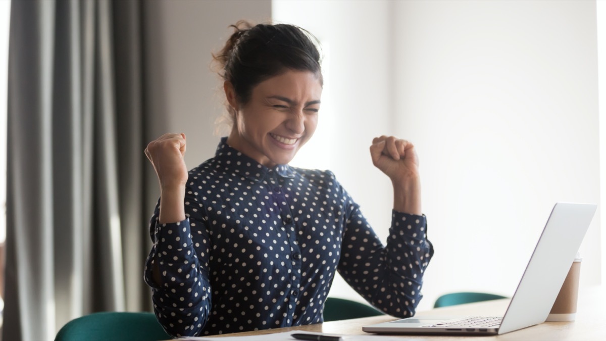 young woman excited about shopping online 