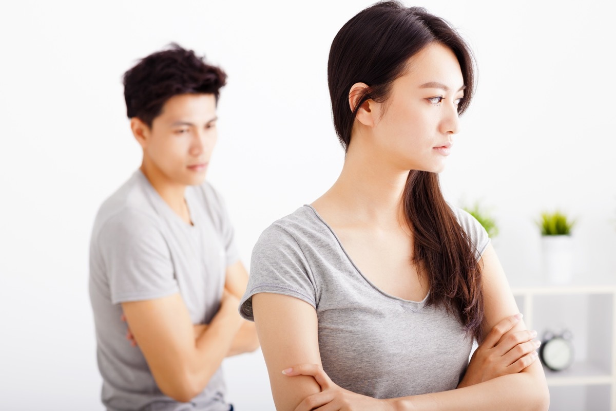 Couple ignoring each other not talking arms crossed