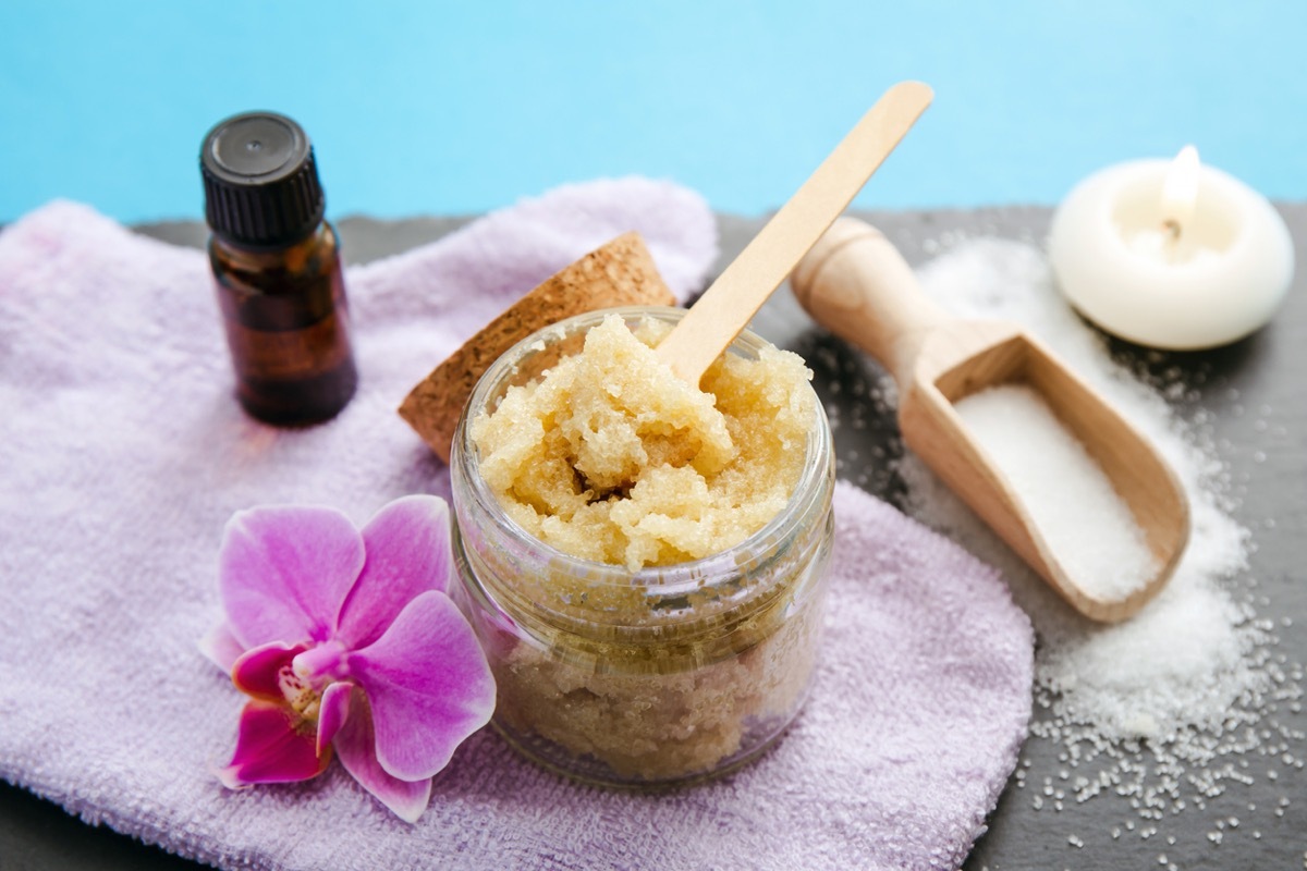 Side view of homemade sugar scrub in glass jar 