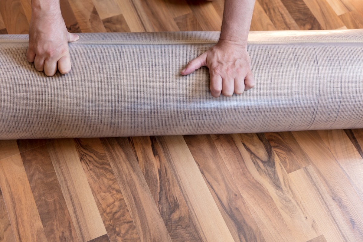 rolling out carpet on floor