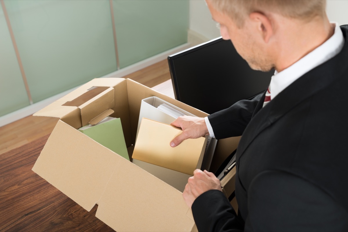 man packing box leaving job