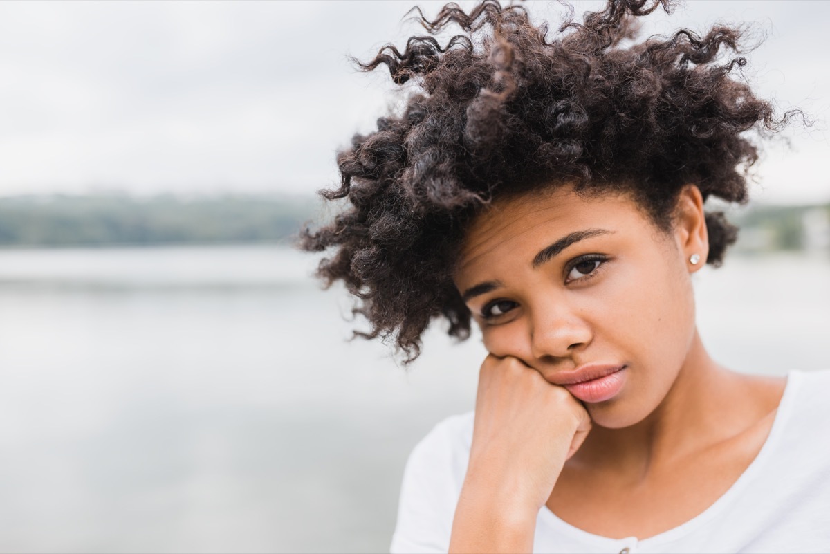 girl with a sad face expression looking at the camera, parent divorce