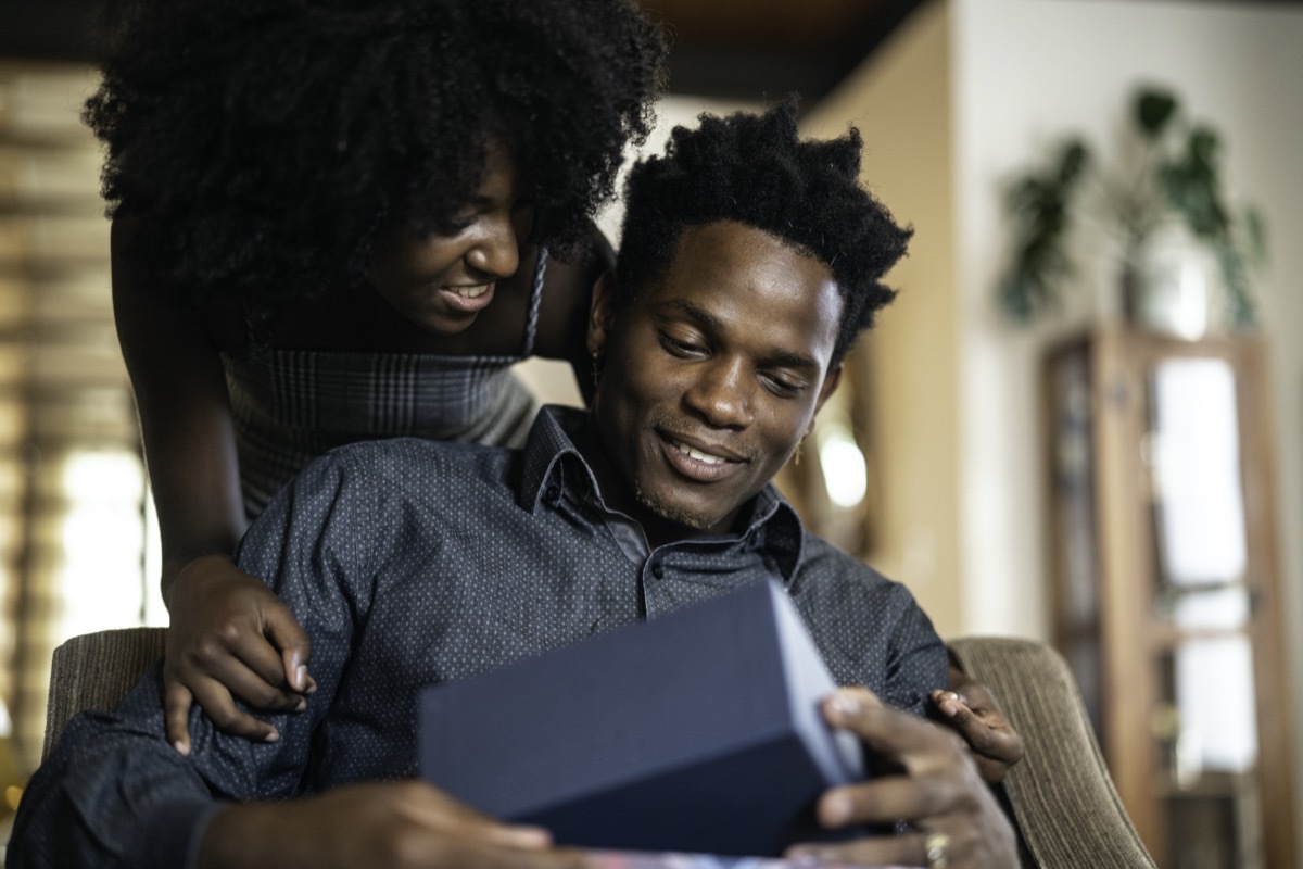 couple exchanging gifts at home.