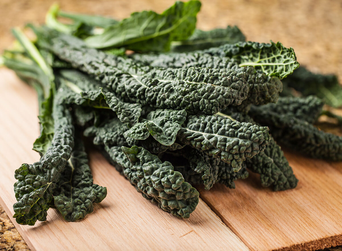 bunch of lacinato kale on wooden board