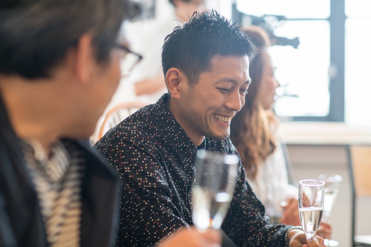 Guests at a dinner party talking and drinking wine