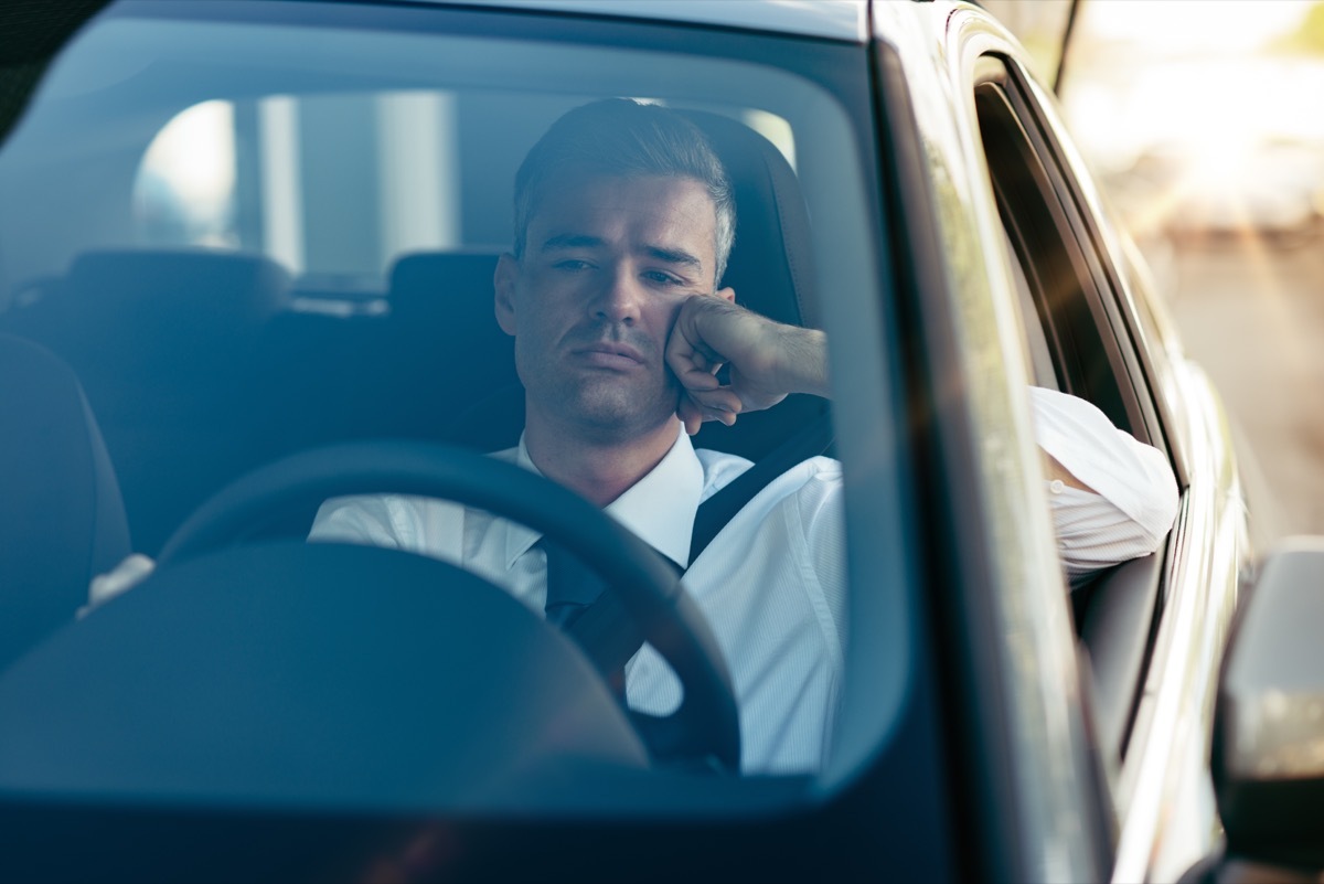 Man sitting in his car sad