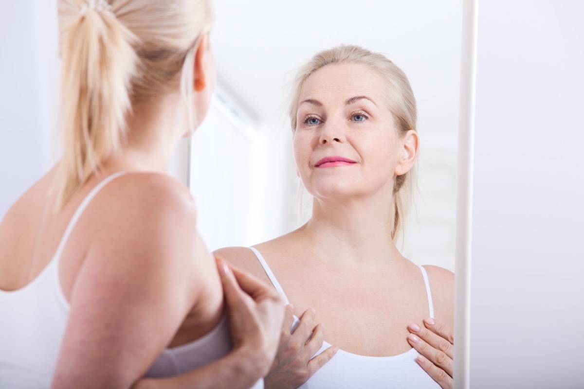 woman looking in mirror, healthy sex after 40