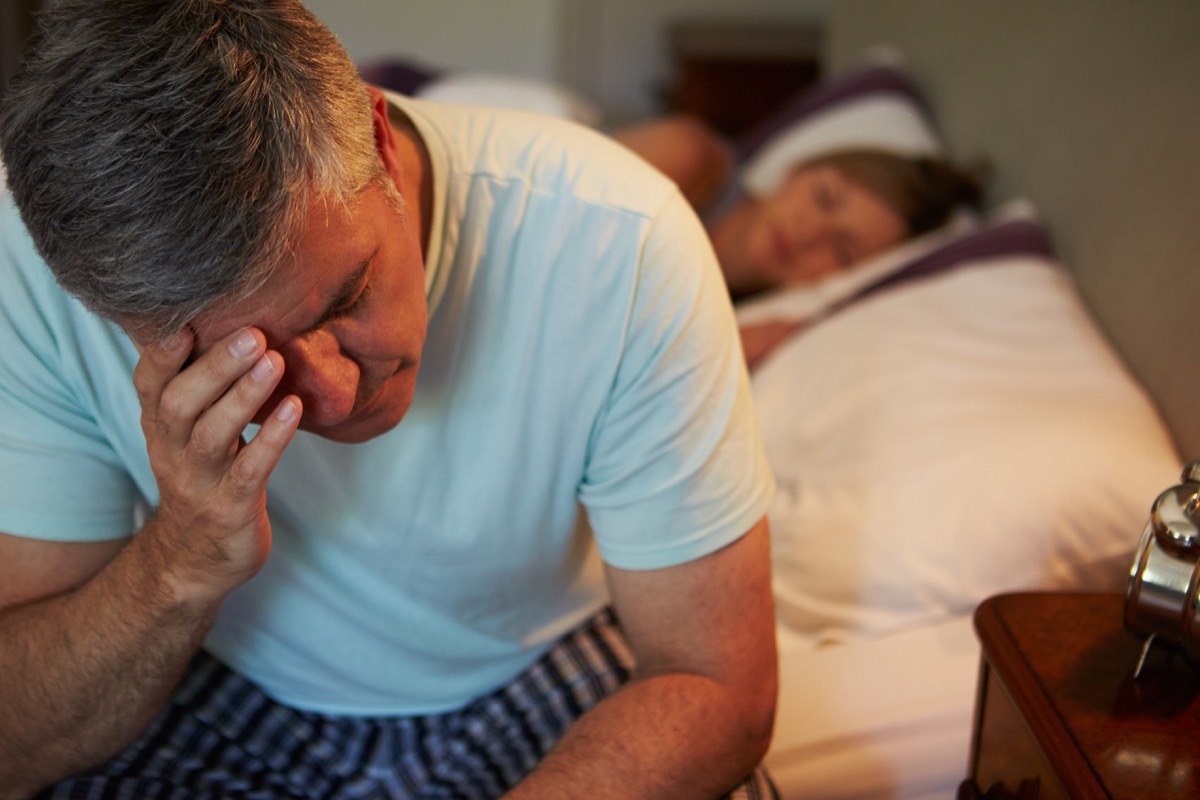 Man stressed in bed suffering from low libido