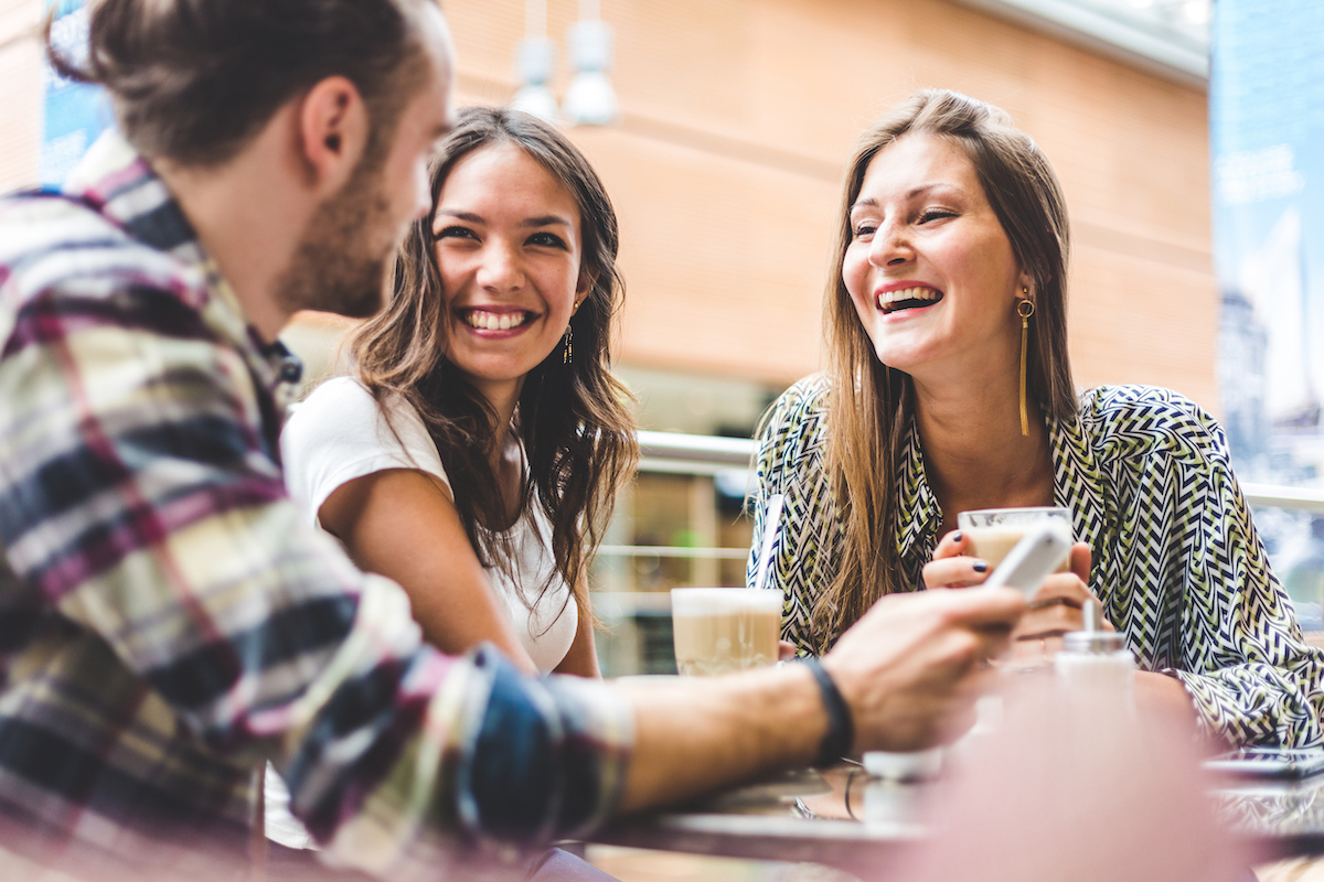 friends laughing around a table