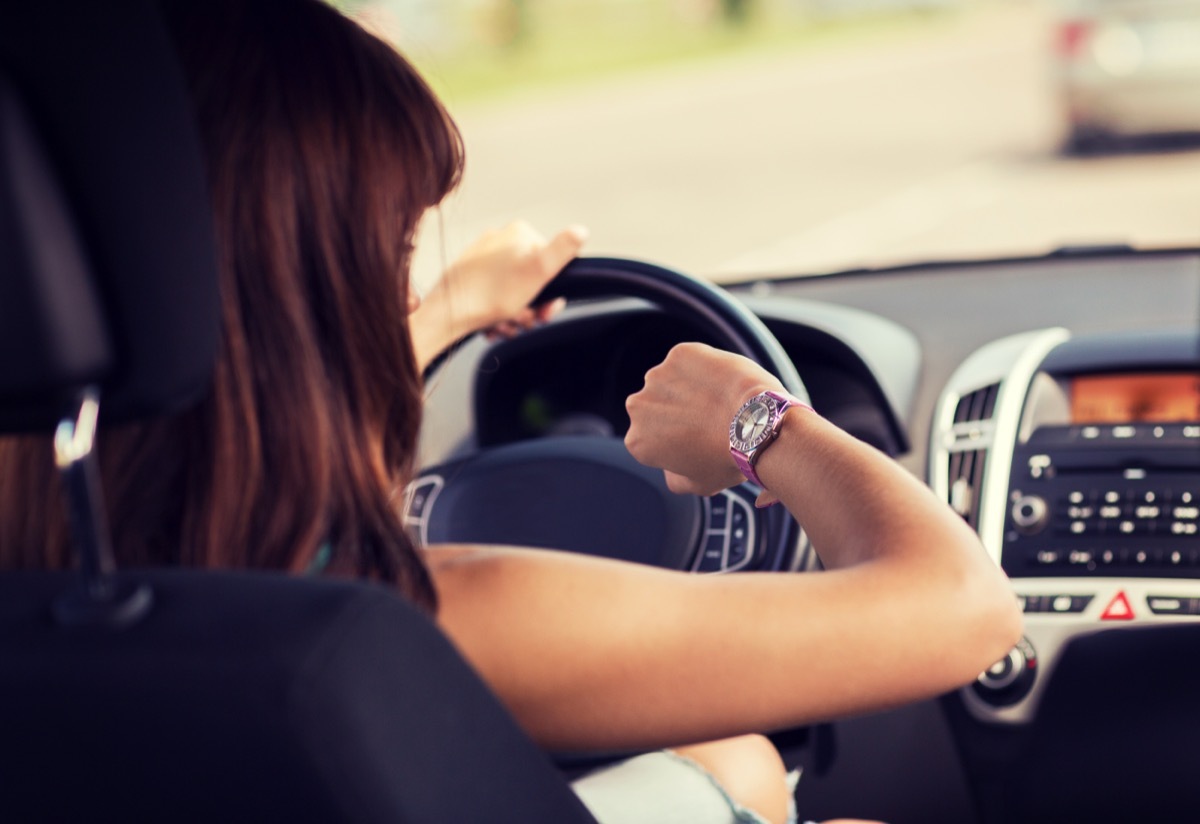 Woman checking her watch running late. 