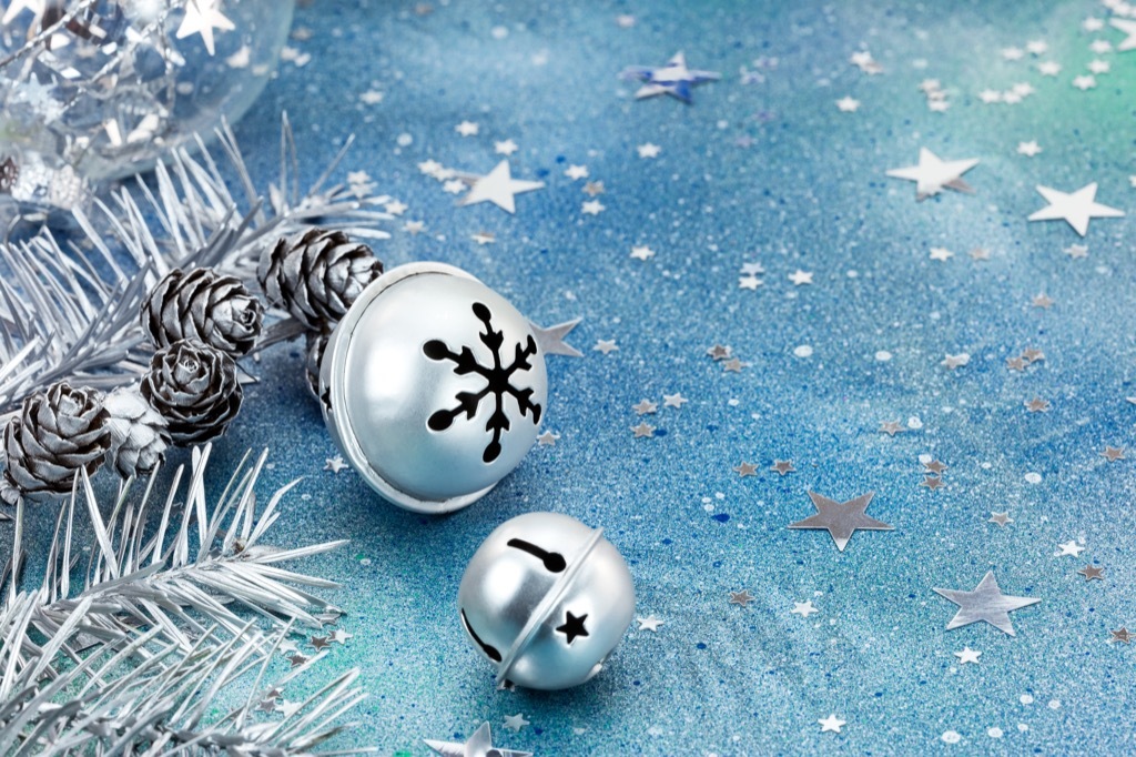 Silver jingle bells on blue background