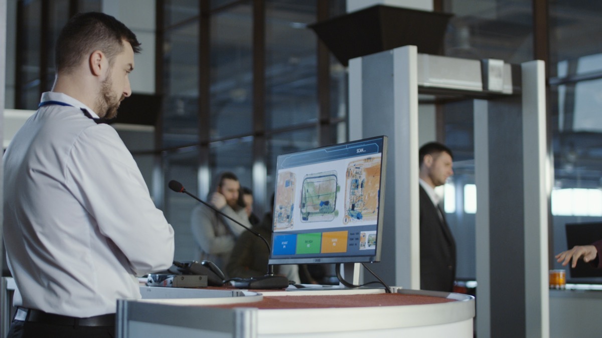 tsa officer looking at baggage