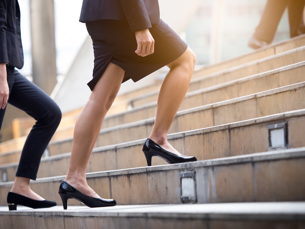 woman walking up steps in heels