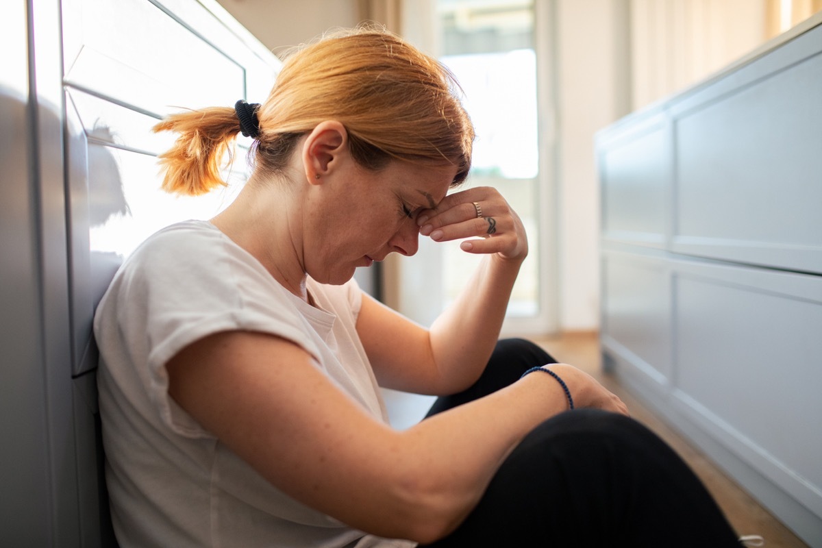 stressed woman sitting on the floor