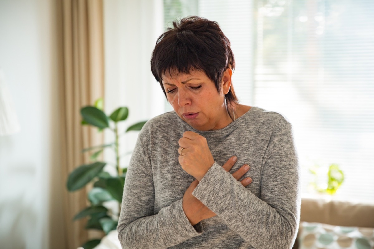 older white woman coughing at home