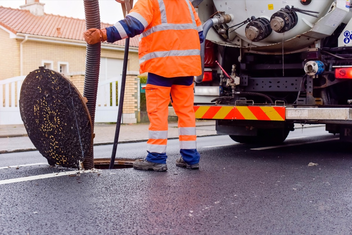 workers unblocking sewers