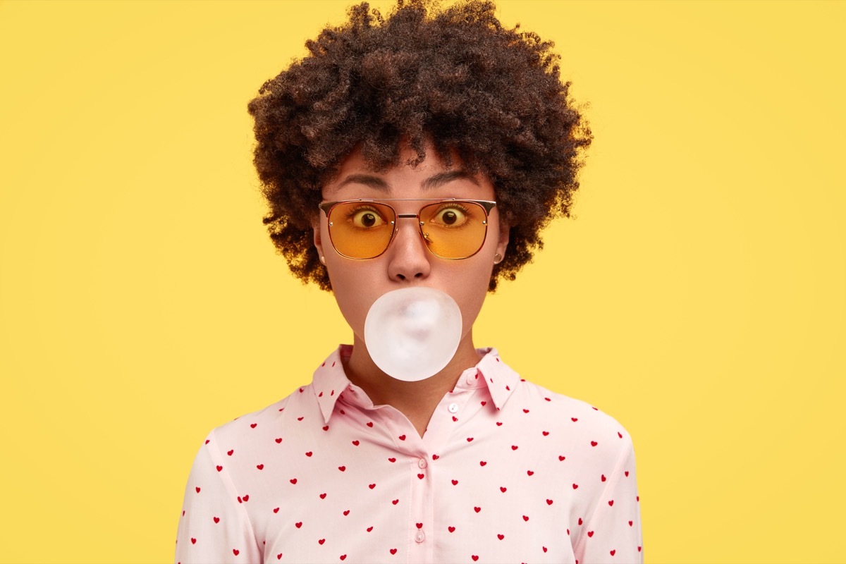 woman blowing gum bubble