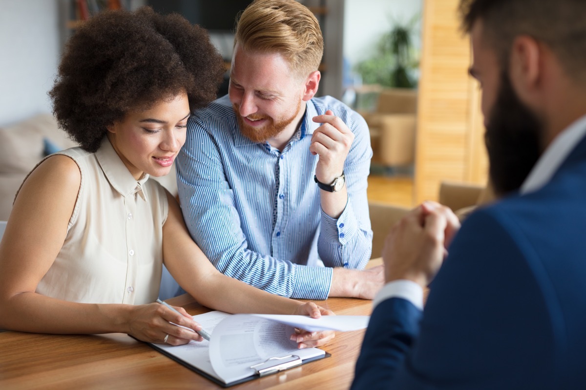 couple talking to a financial advisor about paying off their 