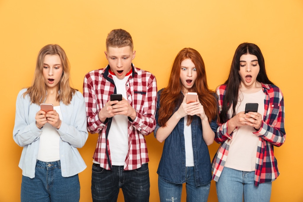 a group of shocked friends against a yellow-orange background