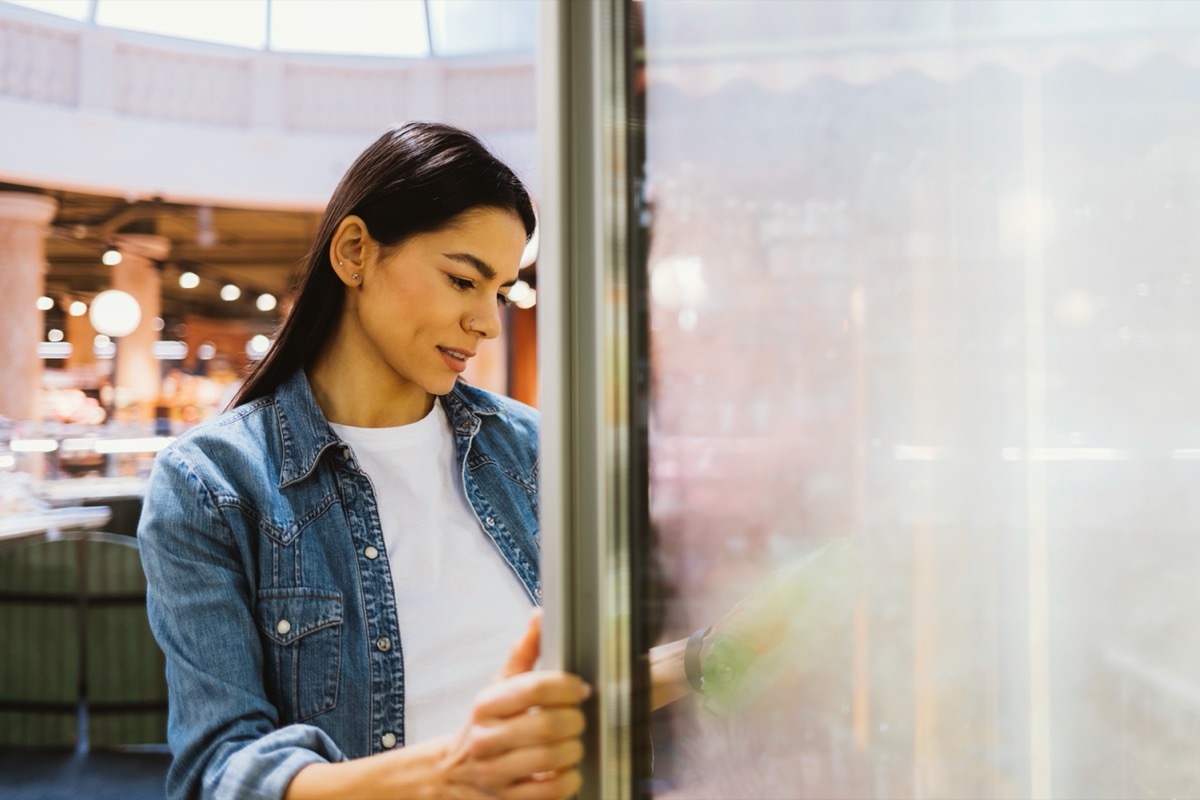 woman buying frozen food at supermarket